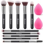 A BEAKEY 12-piece makeup brush set featuring 10 black and silver brushes and 2 blending sponges laid out on a clean surface.