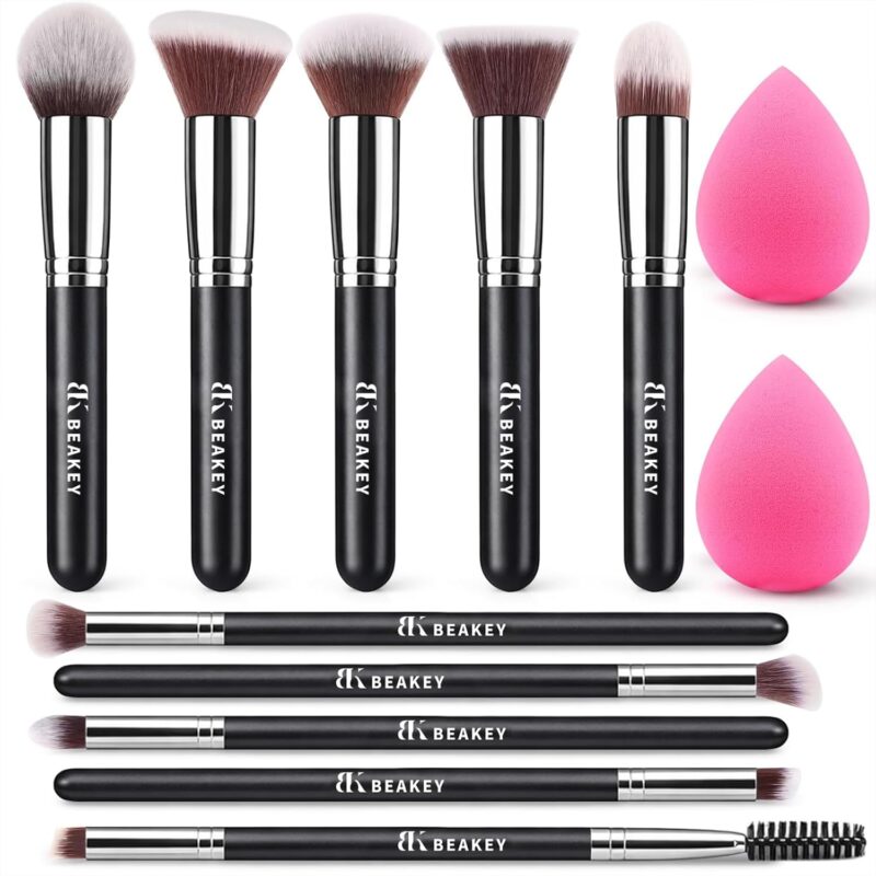A BEAKEY 12-piece makeup brush set featuring 10 black and silver brushes and 2 blending sponges laid out on a clean surface.