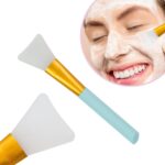 A pink and a blue silicone face mask applicator wand, side by side, showcasing their flexible bristles and ergonomic handles.