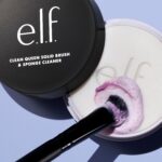 e.l.f. Clean Queen Solid Brush & Sponge Cleaner in its case with a silicone pad, shown next to a wet makeup brush.