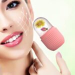 Close-up of the pink striped Joyeee silicone ice facial roller, ready for use on skin.