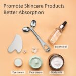 Silver Yeamon stainless steel dual-head facial roller and a matching gua sha tool on a clean surface.